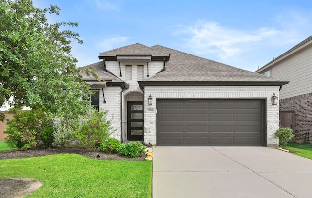 23014 Blackstone Park Rd, Katy, TX 77493 - french country home with brick siding, an attached garage, roof with shingles, driveway, and a front yard