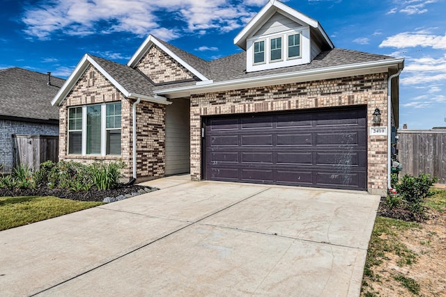2410 Blazing Star Dr, Brookshire, TX 77423 - view of front of property with concrete driveway, brick siding, roof with shingles, and an attached garage