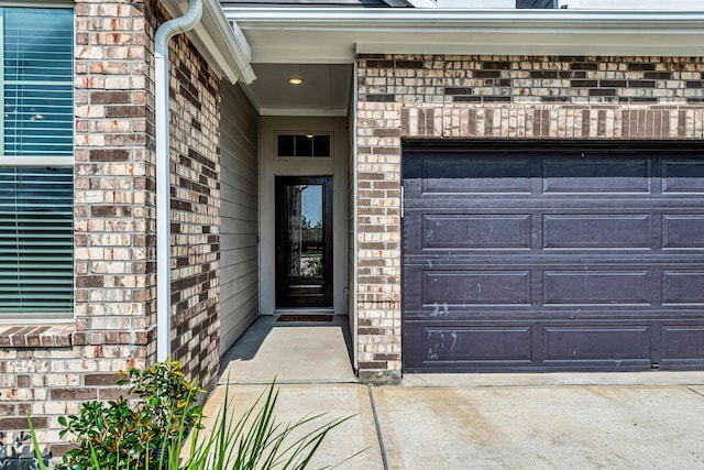 2410 Blazing Star Dr, Brookshire, TX 77423 - view of exterior entry with brick siding, a garage, and driveway