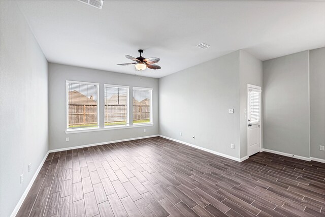 2410 Blazing Star Dr, Brookshire, TX 77423 - empty room featuring dark wood-style floors, a ceiling fan, and baseboards