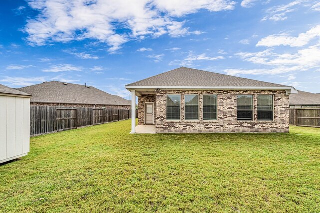 2410 Blazing Star Dr, Brookshire, TX 77423 - back of property featuring brick siding, a patio area, and an outdoor structure