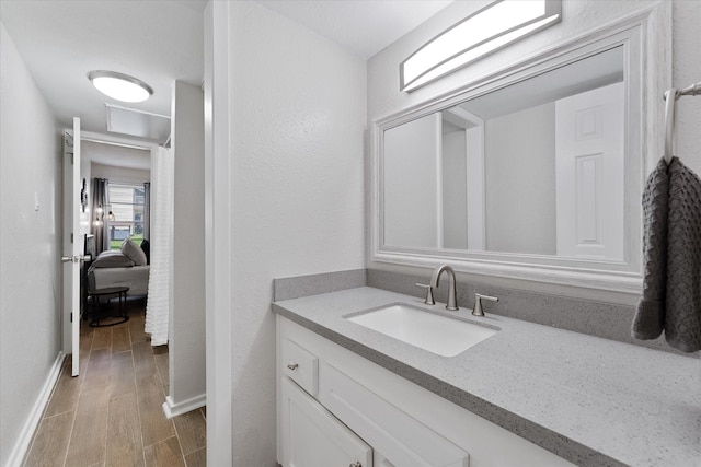 12900 Walden Rd Unit 415D, Montgomery, TX 77356 - bathroom with vanity, wood finished floors, and baseboards