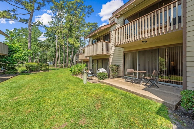 12900 Walden Rd Unit 415D, Montgomery, TX 77356 - view of green lawn with a patio area and a balcony