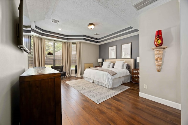 259 W Thorn Way, Houston, TX 77015 - bedroom featuring a tray ceiling, a textured ceiling, baseboards, and dark wood-style floors