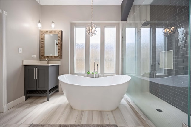 259 W Thorn Way, Houston, TX 77015 - bathroom featuring vanity, tiled shower, a freestanding bath, and a chandelier