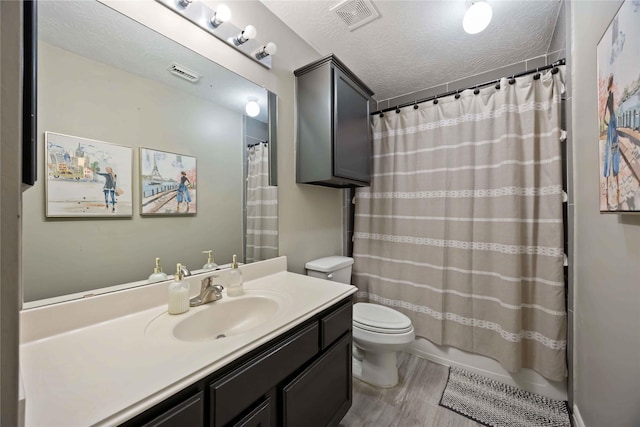 259 W Thorn Way, Houston, TX 77015 - full bath with toilet, vanity, curtained shower, a textured ceiling, and wood finished floors