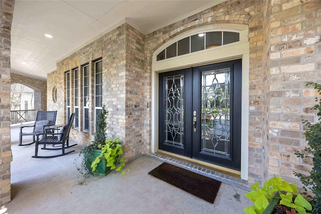 259 W Thorn Way, Houston, TX 77015 - view of exterior entry with a porch and brick siding