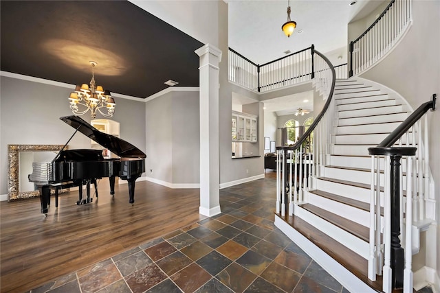 259 W Thorn Way, Houston, TX 77015 - foyer entrance with baseboards, a chandelier, stone tile floors, stairs, and ornamental molding