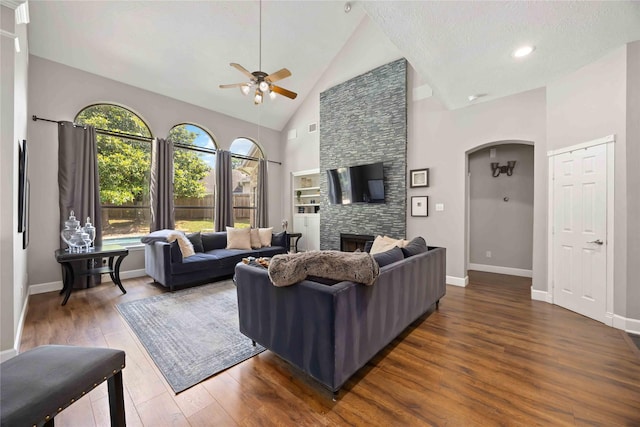 259 W Thorn Way, Houston, TX 77015 - living room with a ceiling fan, wood finished floors, arched walkways, high vaulted ceiling, and baseboards