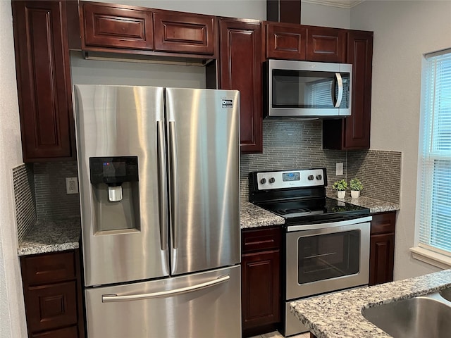 16961 W Hammon, Montgomery, TX 77316 - kitchen with appliances with stainless steel finishes, decorative backsplash, light stone countertops, and crown molding