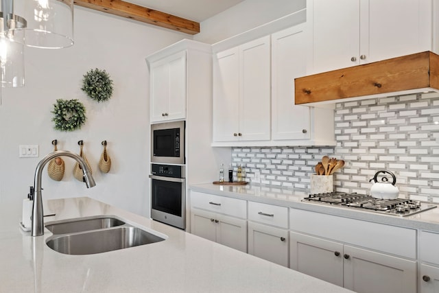 21514 Lost Valley Ln, Porter, TX 77365 - kitchen with stainless steel appliances, a sink, decorative backsplash, light countertops, and beamed ceiling
