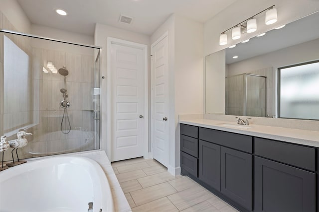 21514 Lost Valley Ln, Porter, TX 77365 - bathroom with a shower stall, vanity, a garden tub, recessed lighting, and a closet