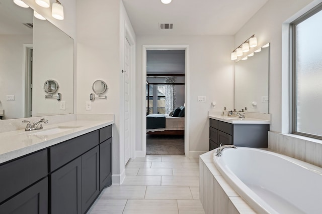 21514 Lost Valley Ln, Porter, TX 77365 - full bath featuring two vanities, connected bathroom, a bath, tile patterned floors, and baseboards