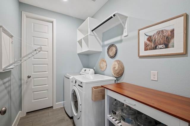 21514 Lost Valley Ln, Porter, TX 77365 - laundry room featuring washing machine and clothes dryer, light wood finished floors, and baseboards