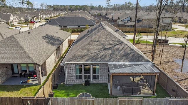 21514 Lost Valley Ln, Porter, TX 77365 - rear view of house with a residential view, a shingled roof, a patio area, brick siding, and a standing seam roof