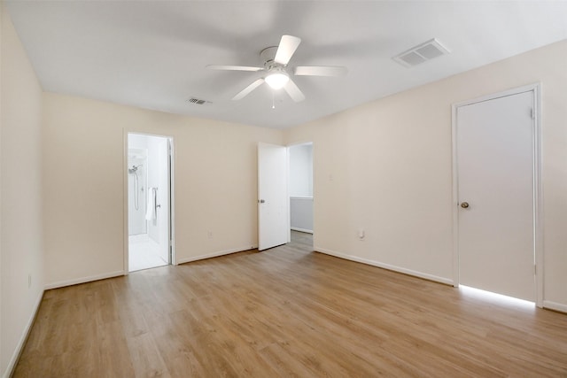 1321 Fountain View Dr Unit 131, Houston, TX 77057 - unfurnished bedroom with light wood finished floors, baseboards, ensuite bathroom, and a ceiling fan