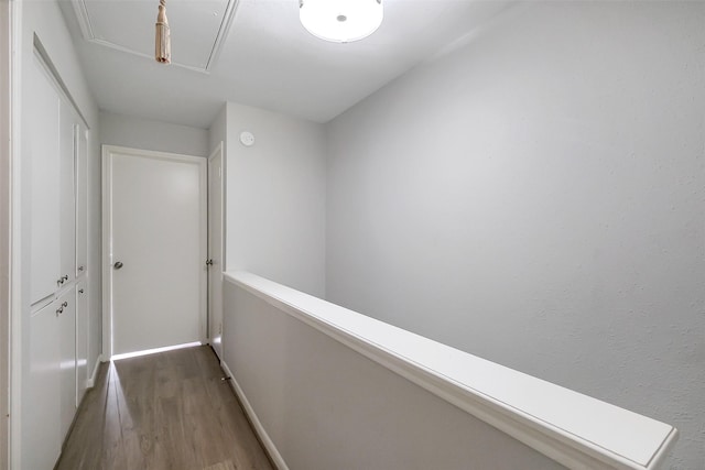 1321 Fountain View Dr Unit 131, Houston, TX 77057 - hallway featuring attic access, wood finished floors, and baseboards