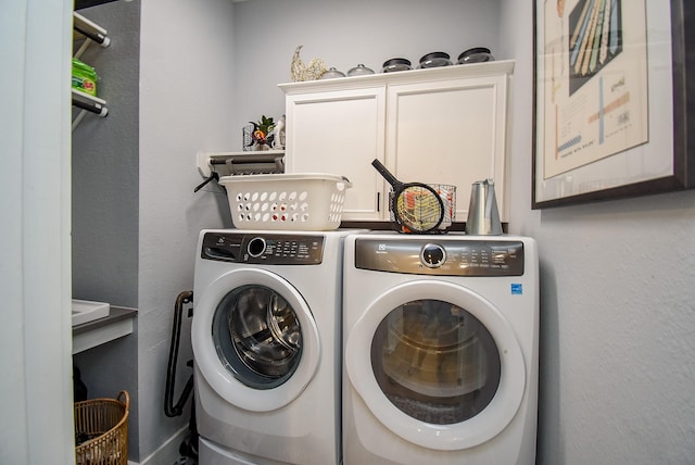 10914 Brambling Wood Dr S, Houston, TX 77043 - washroom with cabinet space and washing machine and dryer