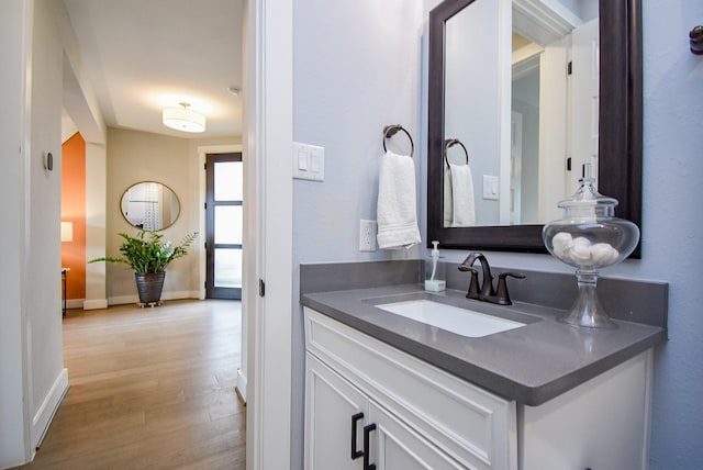 10914 Brambling Wood Dr S, Houston, TX 77043 - bathroom featuring wood finished floors, vanity, and baseboards