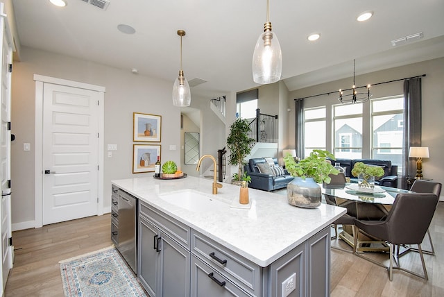 10914 Brambling Wood Dr S, Houston, TX 77043 - kitchen featuring gray cabinets, a sink, dishwasher, open floor plan, and light wood finished floors