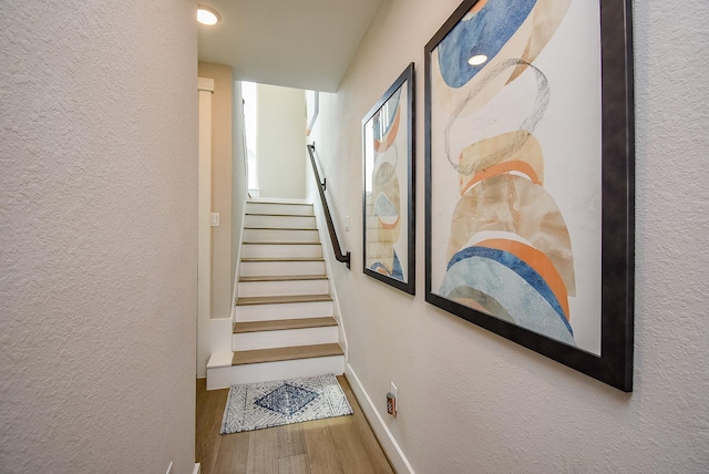 10914 Brambling Wood Dr S, Houston, TX 77043 - stairs with a textured wall, wood finished floors, and baseboards