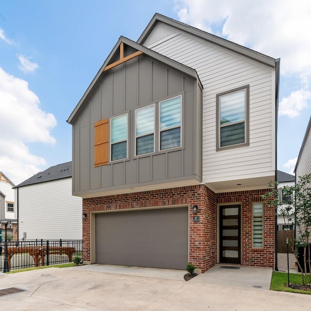 2200 Marnel Rd Unit F, Houston, TX 77055 - view of front of home featuring board and batten siding, brick siding, a garage, and driveway