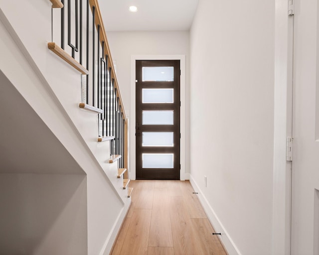 2200 Marnel Rd Unit F, Houston, TX 77055 - doorway with light wood-style flooring, stairway, recessed lighting, and baseboards