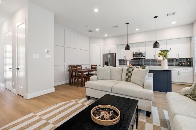 2200 Marnel Rd Unit F, Houston, TX 77055 - living room featuring light wood finished floors, recessed lighting, and baseboards