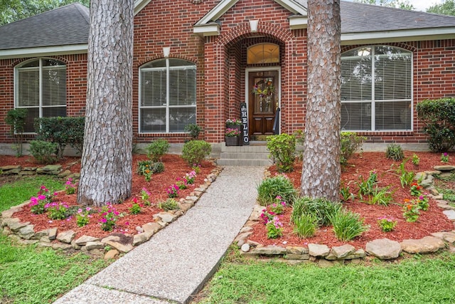 6927 Queensclub Dr, Houston, TX 77069 - view of exterior entry with brick siding and roof with shingles