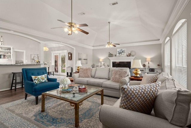 6927 Queensclub Dr, Houston, TX 77069 - living area featuring ceiling fan, arched walkways, a glass covered fireplace, lofted ceiling, and wood finished floors