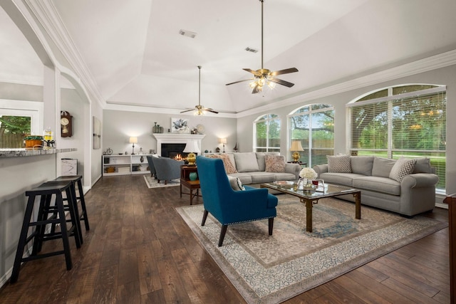 6927 Queensclub Dr, Houston, TX 77069 - living room featuring a warm lit fireplace, dark wood-style floors, lofted ceiling, ceiling fan, and ornamental molding