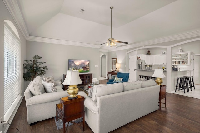 6927 Queensclub Dr, Houston, TX 77069 - living room with dark wood finished floors, a ceiling fan, a tray ceiling, arched walkways, and ornamental molding