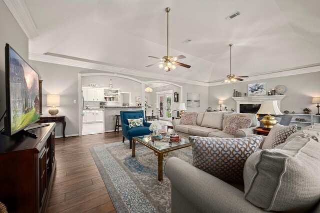 6927 Queensclub Dr, Houston, TX 77069 - living area featuring arched walkways, ceiling fan, dark wood finished floors, lofted ceiling, and a fireplace