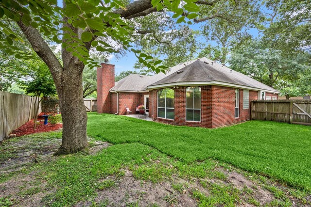 6927 Queensclub Dr, Houston, TX 77069 - rear view of property with a chimney and brick siding