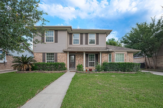 13315 Rain Lily Ln, Houston, TX 77083 - traditional-style house with brick siding and a front yard