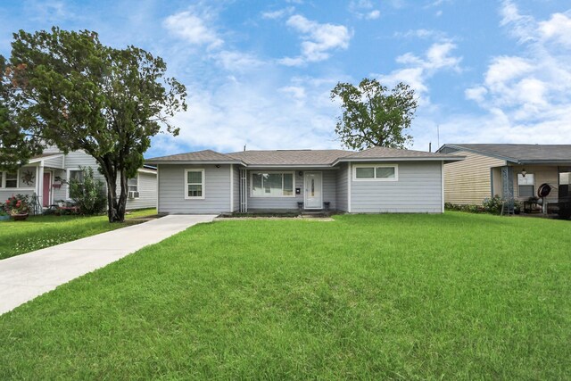 119 Burke Rd, Pasadena, TX 77506 - ranch-style home with a front yard and concrete driveway