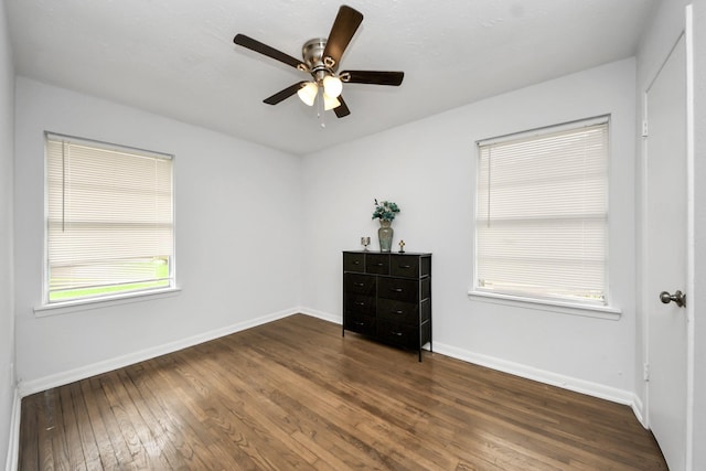 119 Burke Rd, Pasadena, TX 77506 - unfurnished bedroom with dark wood-style floors, baseboards, and multiple windows
