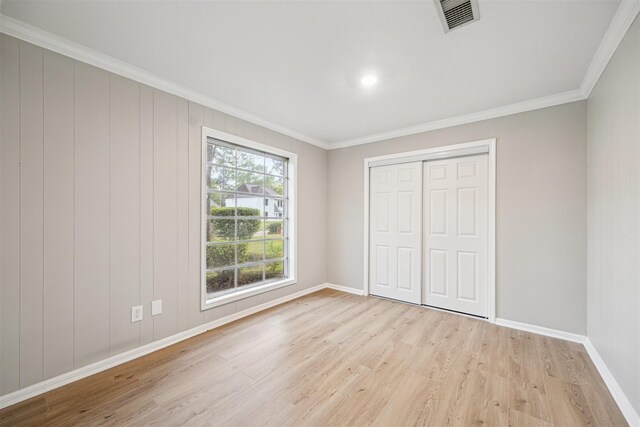 1802 Corral Dr, Houston, TX 77090 - unfurnished bedroom with light wood-style flooring, crown molding, baseboards, and a closet