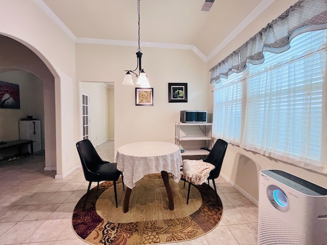 21607 Goloby Dr, Richmond, TX 77407 - dining space featuring light tile patterned floors, crown molding, arched walkways, and baseboards