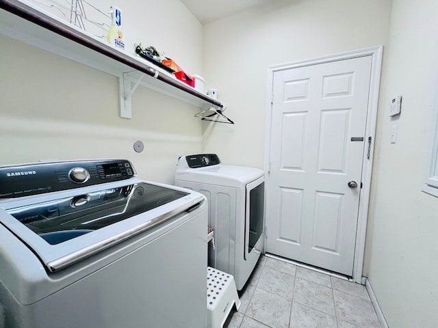 21607 Goloby Dr, Richmond, TX 77407 - laundry room featuring separate washer and dryer and baseboards