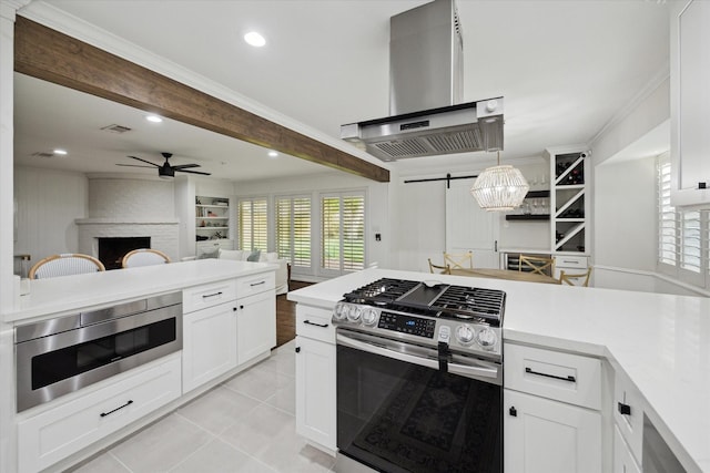 10043 Overbrook Ln, Houston, TX 77042 - kitchen featuring appliances with stainless steel finishes, extractor fan, a barn door, open floor plan, and ceiling fan