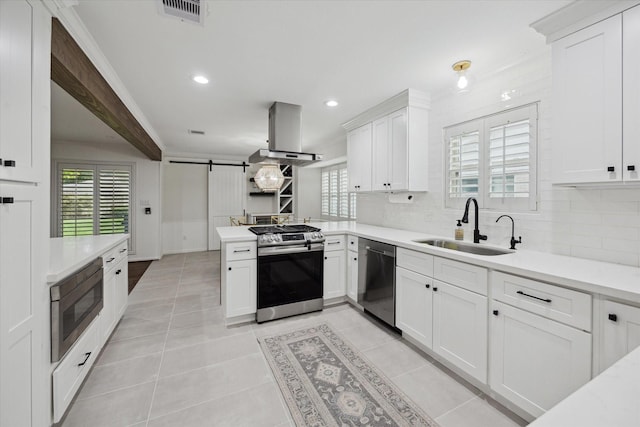 10043 Overbrook Ln, Houston, TX 77042 - kitchen with appliances with stainless steel finishes, a sink, island exhaust hood, a peninsula, and backsplash