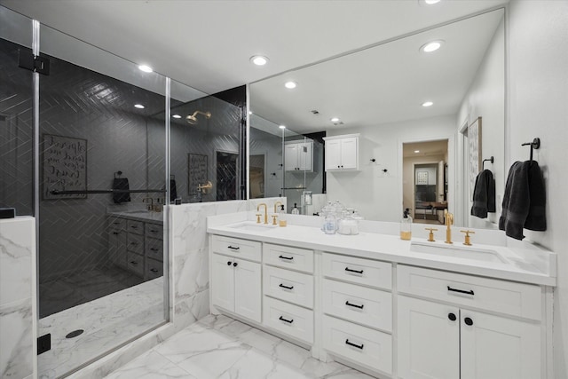 10043 Overbrook Ln, Houston, TX 77042 - full bathroom with double vanity, marble finish floors, a marble finish shower, and recessed lighting