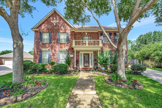 3602 Garrettsville Dr, Pearland, TX 77584 - colonial inspired home with a balcony, brick siding, and a garage