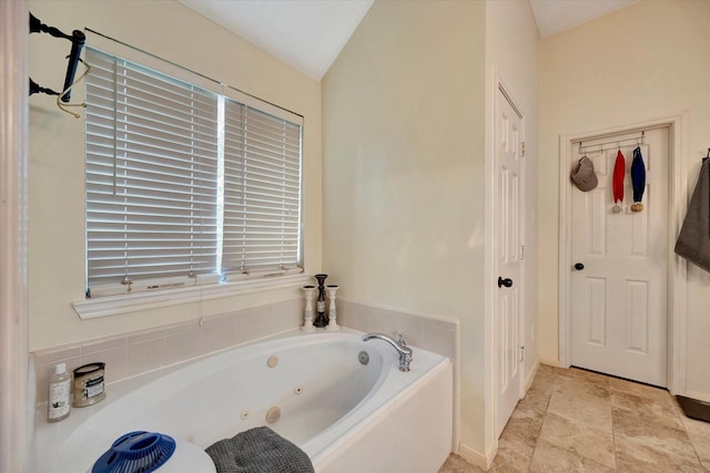 3602 Garrettsville Dr, Pearland, TX 77584 - full bath with a tub with jets, lofted ceiling, and baseboards