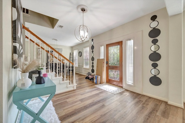 3602 Garrettsville Dr, Pearland, TX 77584 - entryway with stairs, wood finished floors, a chandelier, and baseboards