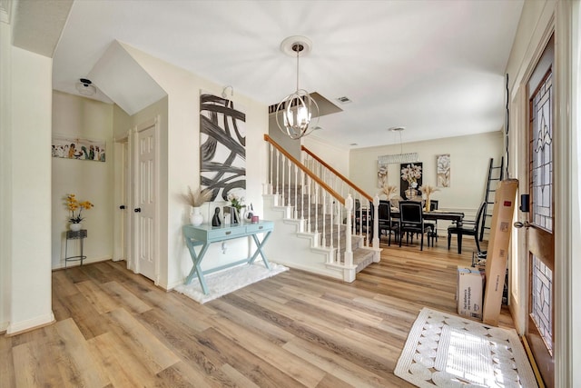 3602 Garrettsville Dr, Pearland, TX 77584 - entrance foyer with a chandelier, light wood-type flooring, stairway, and baseboards