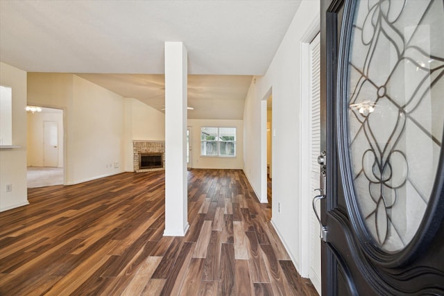 2818 Cocona Ln, Houston, TX 77073 - entrance foyer with dark wood finished floors, a brick fireplace, and baseboards