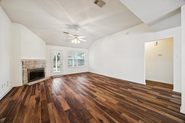 2818 Cocona Ln, Houston, TX 77073 - unfurnished living room with dark wood-style floors, a ceiling fan, lofted ceiling, and a brick fireplace