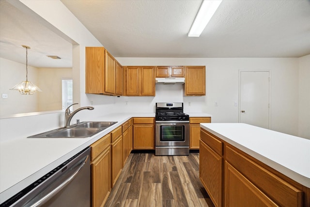 2818 Cocona Ln, Houston, TX 77073 - kitchen with appliances with stainless steel finishes, a sink, under cabinet range hood, dark wood-style flooring, and light countertops